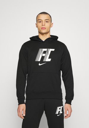 Schwarzer Hoodie mit einer Fronttasche, der ein auffälliges weißes Nike-Logo und stilisierte Schriftzüge zeigt. Weicher Stoff mit lockerer Passform.
