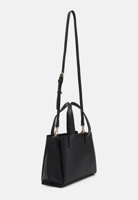 Black, textured leather handbag with dual top handles and an adjustable shoulder strap. Features gold hardware and geometric design.