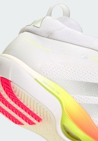 Gros plan sur le talon de la basket blanche Adidas CrazyFlight 7 avec amorti Lightstrike Pro et détails rouges sur la semelle.