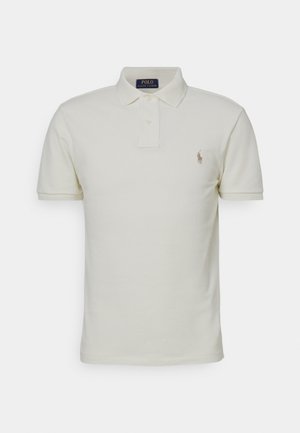 Helebeež polo-särk, mis on valmistatud puuvillast, klassikalise kraega, lühikeste varrukatega ja vasakul rinnal väikese brodeeritud logoga.