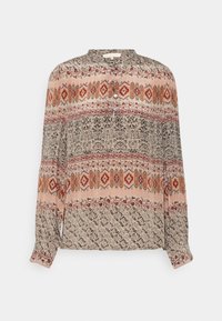 Blouse à manches longues avec col mandarin, présentant des motifs floraux et losanges complexes dans des tons de beige, rouille et noir.