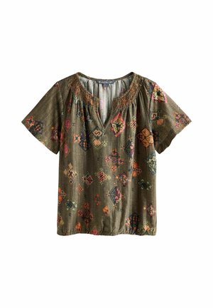 Short-sleeve olive green blouse with multicolored geometric patterns, gathered neckline with fringe detail, and slight v-neck opening.