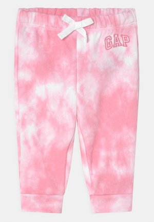 Różowo-białe spodnie dziecięce tie-dye z elastycznym pasem, białą kokardką, mankietami przy kostkach i logo GAP na lewym biodrze.