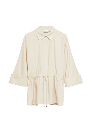 Beżowa bluzka z długim rękawem z kołnierzykiem, ukrytymi przednimi guzikami, regulowanym sznurkiem w talii i szerokimi mankietami podwiniętymi do góry.