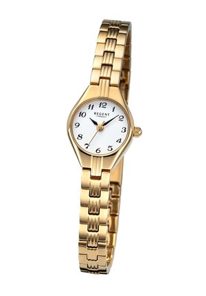 Montre dorée avec un cadran blanc, des repères en chiffres arabes, un boîtier octagonal et un bracelet en métal poli avec un design texturé.