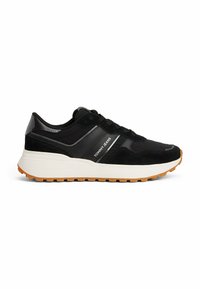 Zapatillas deportivas negras que presentan una combinación de parte superior de ante y sintético, entresuela blanca y suela de goma. Incluye detalles de la marca en plateado.