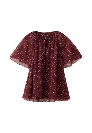 Blouse bordeaux transparente à pois blancs, coupe ample, manches volantées et encolure arrondie avec un petit lien sur le devant.