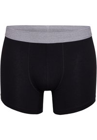 Bóxer de algodón negro con una cintura elástica gris, con detalles de costura y un diseño ajustado. Textura suave, longitud media en el muslo.