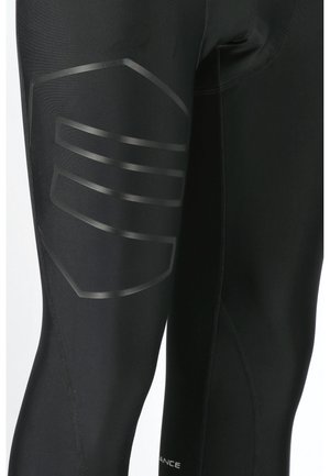 Sorte atletiske leggings med et glansfuldt sort stribedesign på ydersiden af låret og flade syninger for øget holdbarhed.