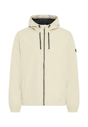 Beige capuchonjack met zwarte trekkoorden, ritssluiting aan de voorkant, elastische manchetten en een klein zwart label op de linkermouw.