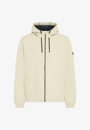 Beige hettejakke med svarte snorer, glidelås foran, elastiske mansjetter og et lite svart merke på venstre erme.