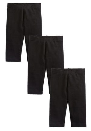 Drei Paar schwarze knielange Leggings, diagonal auf weißem Hintergrund angeordnet.