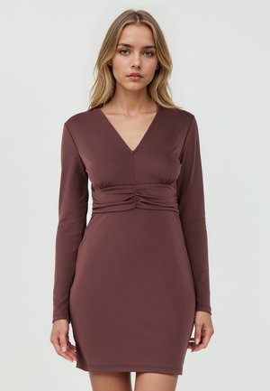 Long-sleeve, fitted brown dress with a V-neck and gathered front detail. Smooth, stretchy fabric with a mid-thigh length.