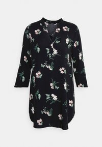 Svart långärmad tunika klänning med rosa och vita blommor samt gröna fjärilstryck, med V-ringning och tre knappar på bröstet.