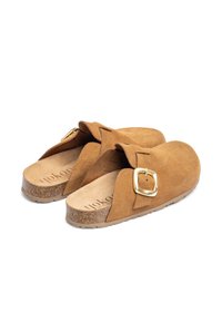 Zoccoli in suede marrone con una fascia ampia e una fibbia rettangolare dorata. Sole in sughero con una texture liscia e bordi leggermente rialzati.