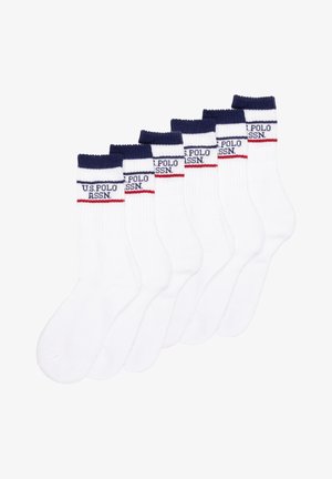 Cotton white athletic socks with navy ribbed cuffs. Each sock features a red and navy stripe and “U.S. POLO ASSN.” logo. Set of six.