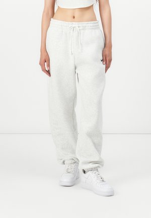 Pantalons de survêtement gris clair en tissu doux, avec une taille élastique et un cordon de serrage, coupe décontractée et poches latérales.