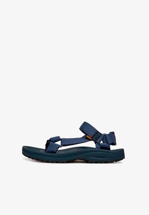 Sandale extérieure bleu marine avec brides ajustables, semelle texturée et fermeture Velcro pour un maintien sécurisé et un confort optimal.