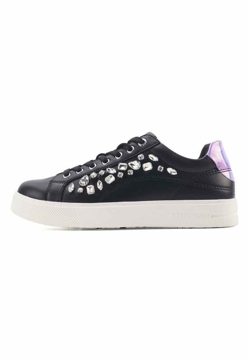 Black low-top sneakers with a smooth texture, embellished with multi-shaped rhinestones, and a white rubber sole. Purple accents on the heel.
