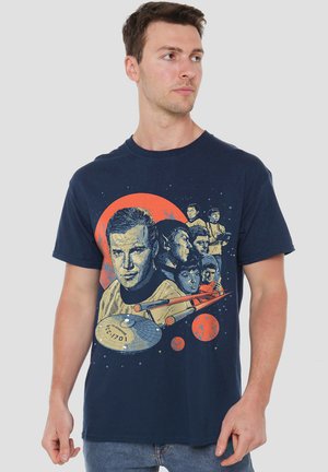 Navy blue cotton t-shirt featuring a graphic print of characters and a spaceship against an orange circle, with detailed illustrations.