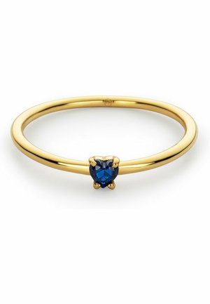 Goldring mit einem herzförmigen blauen Stein. Glatte Fassung mit polierter Oberfläche, vier Krappen, die den Edelstein sicher halten.