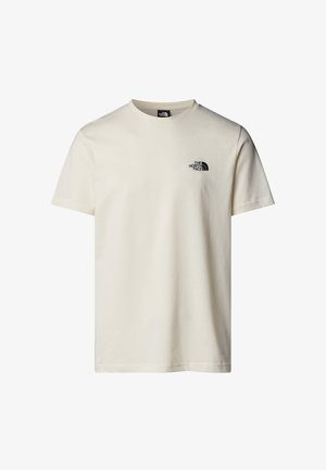 T-shirt en coton couleur crème avec des manches courtes, un col rond et un petit logo noir sur la poitrine gauche. Texture lisse, coupe classique.