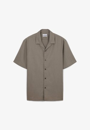 Chemise à manches courtes, col, en tissu marron clair avec une finition texturée et cinq boutons marron sur le devant.