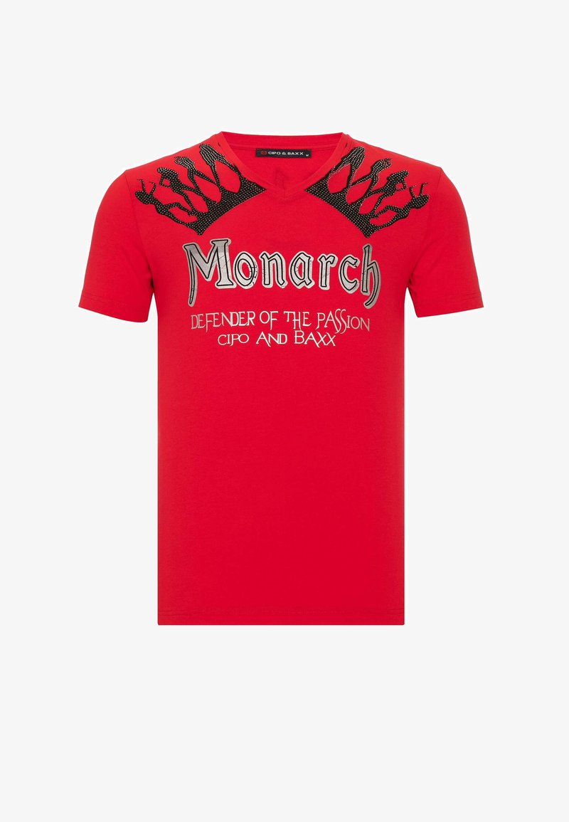 Red short-sleeve T-shirt featuring a V-neck, metallic graphic text "Monarch" and crown design with intricate details on shoulders.