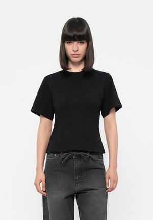 Black short-sleeve top with a round neckline, fitted bodice, and slight peplum hem. Made of smooth, stretchy fabric. Minimalist design.