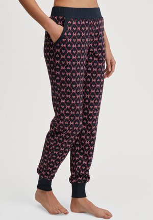 Navy Jogginghose mit einem pinken Herz- und Schleifenmuster, Rippenbund, seitlichen Taschen und schmal zulaufenden Bündchen. Weicher Stoff mit glatter Textur.