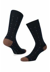 Granatowe skarpetki z prążkowanym mankietem, ozdobione małymi białymi i brązowymi kropeczkami. Brązowe wzmocnienia na pięcie i palcach, wykonane z dzianiny.