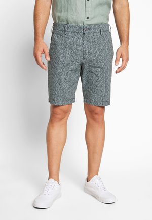 Mønstret shorts i mørkt teal med små hvide blomsterprint, lavet af letvægtsstof, med knaplukning og sidelommer.