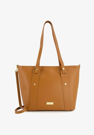 Hnědá syntetická taška přes rameno s dvěma dlouhými uchy, zlatými akcenty a obdélníkovým tvarem. Obsahuje prošívané detaily a logo štítek.