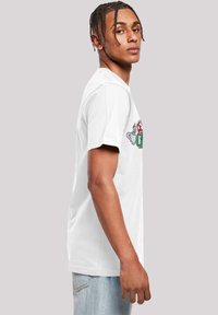 White cotton T-shirt featuring a colorful graphic print on the front. Short sleeves and a round neckline. Soft, smooth texture.