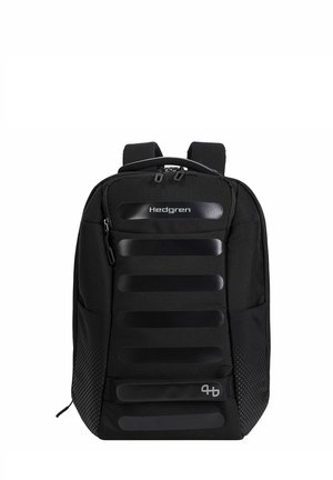 Black Hedgren backpack with front zip pocket, padded straps, and horizontal reflective stripes on the main compartment.