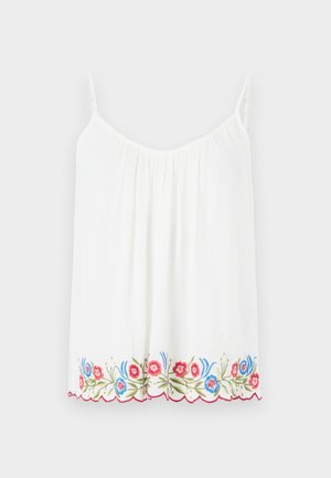 Fehér ujjatlan felső, fodros nyakkivágással és piros, kék és zöld virágos hímzéssel az alján, ráadásul fodros széllel.