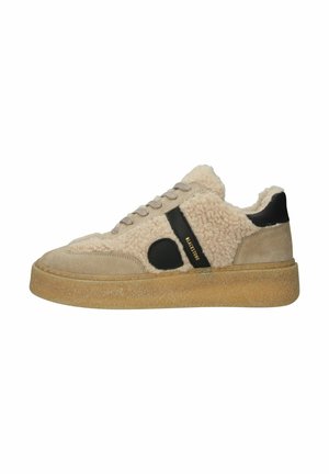 Beige sneaker with brown shearling upper, black leather accent, round toe, flat rubber sole, and lace-up front. Gold branding detail on side.