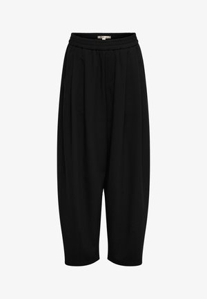 Laisvos juodos spalvos trumpintos kelnės su elastine liemene ir šoninėmis kišenėmis, išsiskiriančios laisvu kirpimu ir siaurėjančiomis kojų apačiomis.