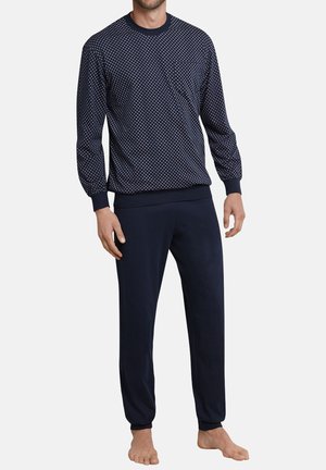 Marineblaues Langarmoberteil mit weißen Punkten, kombiniert mit einfarbigen marineblauen Jogginghosen. Hergestellt aus weichem Stoff mit gerippten Bündchen.