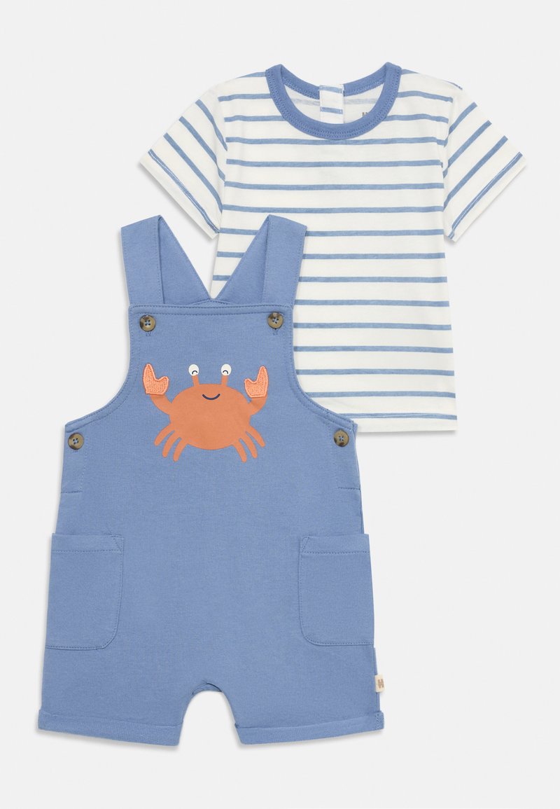 Blue overalls with a crab design, buttons on straps, and pockets. Paired with a white and blue striped short-sleeve T-shirt.