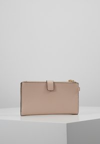Leather wallet in soft beige, rectangular shape with textured surface, a snap closure, and a gold-tone zipper detail along the edge.