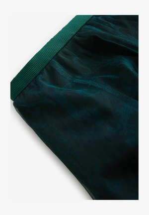 Dunkelgrüne Mesh-Shorts mit strukturiertem Bund und dezentem Musterdesign, die einen leichten und atmungsaktiven Stoff präsentieren.