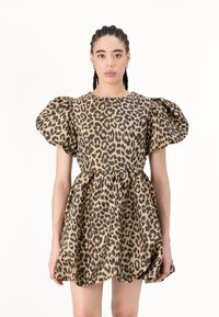 Leopard print dress featuring puff sleeves, a fitted bodice, and a flared skirt. Made from a textured fabric in shades of brown and beige.