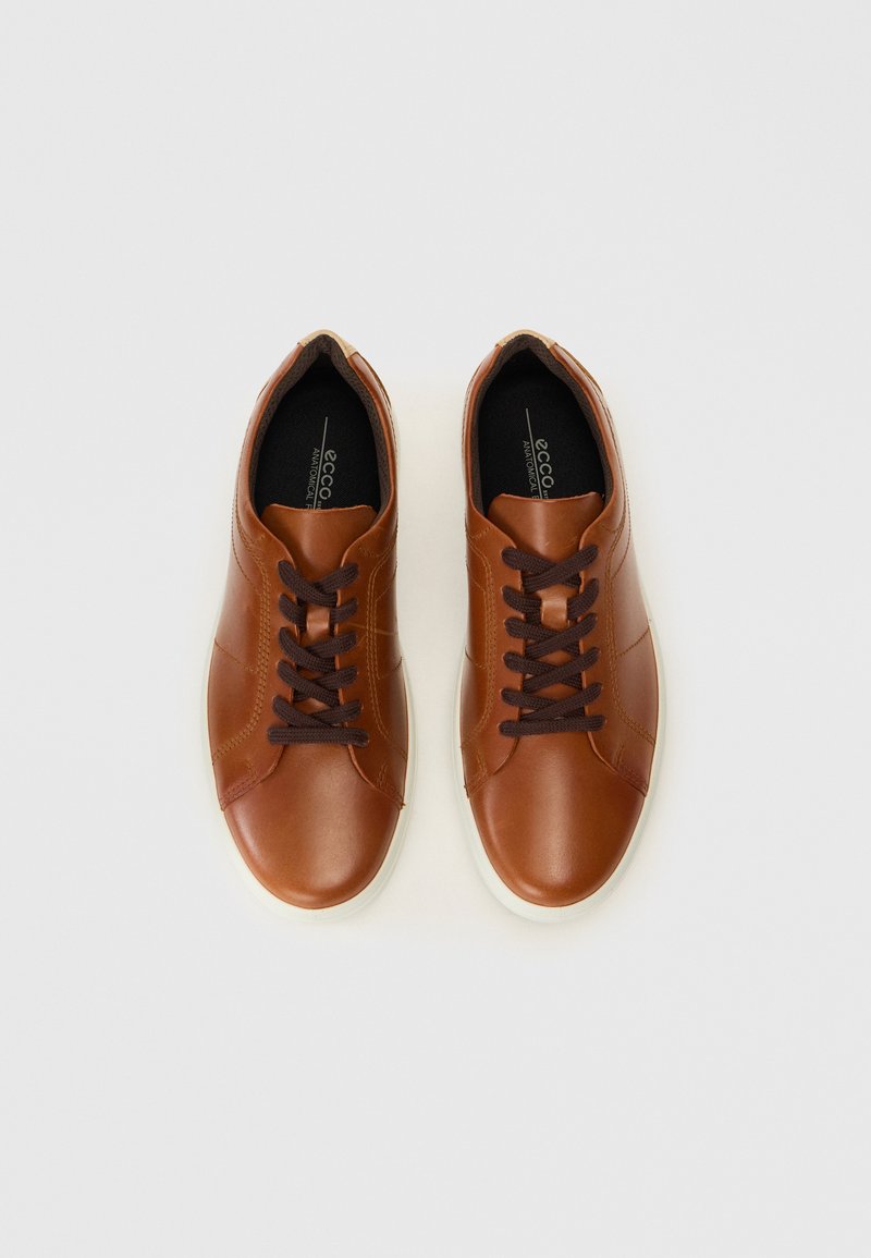 Braune LederSneakers mit glatter Textur, dunkelpaarigen Schnürsenkeln, abgerundeter Spitze und heller Gummi-Sohle.