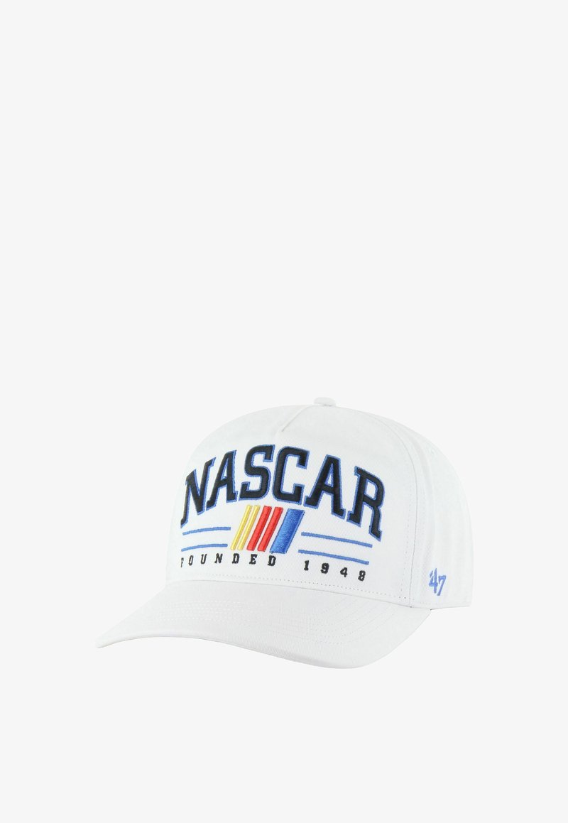 White baseball cap featuring "NASCAR" logo in blue with red and yellow stripes. The text "Founded 1948" and "47" logo on the side.