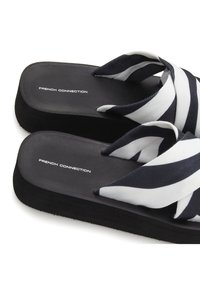 Black platform flip-flops with navy and white striped fabric straps. "FRENCH CONNECTION" logo printed on the insole. Textured sole.