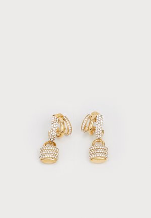 Gold earrings featuring intertwined loops with a textured, crystal-embellished pendant resembling a padlock. Sparkling finish and intricate design.