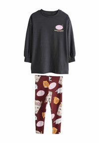 Black long-sleeve top with "BUBBLE" graphic and maroon leggings featuring playful cat and drink patterns. Made of soft cotton fabric.
