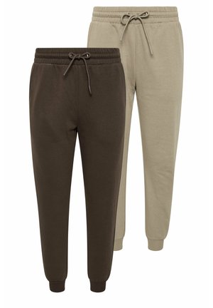 Dos pares de pantalones jogger con cinturillas elásticas y cordones, uno marrón oscuro y otro beige claro, mostrados uno al lado del otro sobre un fondo blanco.