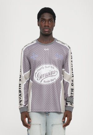 Long-sleeve, gray patterned shirt with text and logo. Features a checkered design, contrasting shoulder accents, and soft fabric.